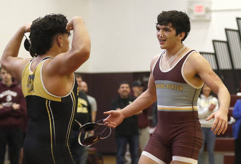 Harvard’s Gabe Sanchez raises his arms to Richmond-Burton’s Alex Reyna after Sanchez  defeated Reyna in their 182-pound championship wrestling match in the IHSA 1A Richmond-Burton Wrestling Regional Thursday, Jan. 19, 2023, at Richmond-Burton High School in Richmond.