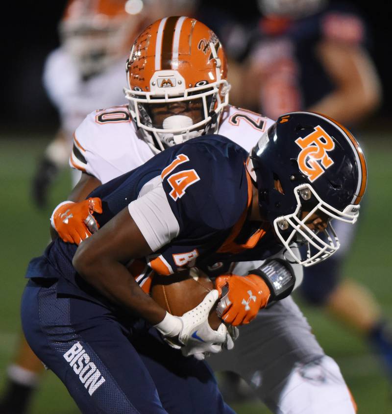 Joe Lewnard/jlewnard@dailyherald.com
Buffalo Grove's Jalon Marshall, front, gets tackled by Hersey’s Brandon Jenkins during Friday’s game in Buffalo Grove.