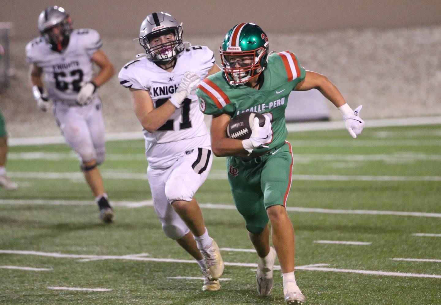L-P's Rylynd Rynkewicz sprints down the field as Kaneland's Jackson Little chases after him on Friday, Oct. 17, 2025 at Howard Fellows Stadium.