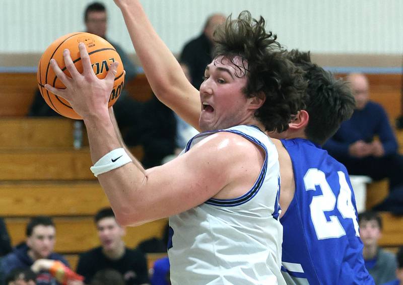 Hinckley-Big Rock's Martin Ledbetter pulls down a rebound in front of Rochelle Zell’s Lev Dolinsky during their game Tuesday, Dec. 17, 2024, at Hinckley-Big Rock High School.