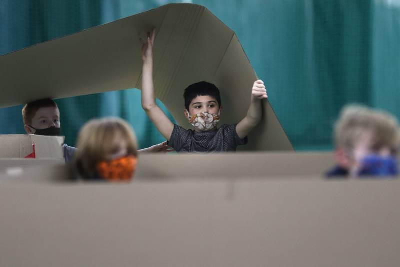 Leo Ruiz of Crystal Lake, 9, holds up cardboard as his team and 16 other teams compete during the annual Forts on the Courts event held by the Crystal Lake Parks District on Saturday, March 13, 2021 at The Racket Club in Algonquin. Seventeen teams received three pieces of cardboard and one roll of duct tape to create a unique design in an hour and a half which would be voted on by all participants for two gift card prizes each valued at $50 to Lou Malnati's and the Crystal Lake Parks District. Participants were also treated to a donated scoop of ice cream from Baskin Robbins in Crystal Lake at the end of the event.