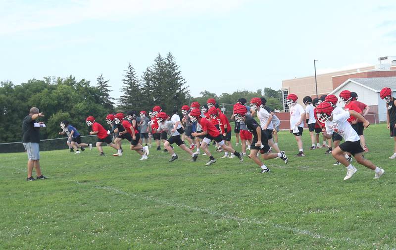 Hall football head coach Nick Sterling, works with his team during the first day of football practice on Monday, Aug. 11, 2025 at Hall High School.