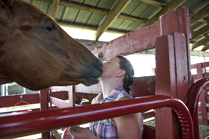 2019 FILE: Emily Sachs of the Young Seekers 4H club, gets a smooch from Alibi, the horse of friend Lucas Odle during the Lee County 4H Fair.