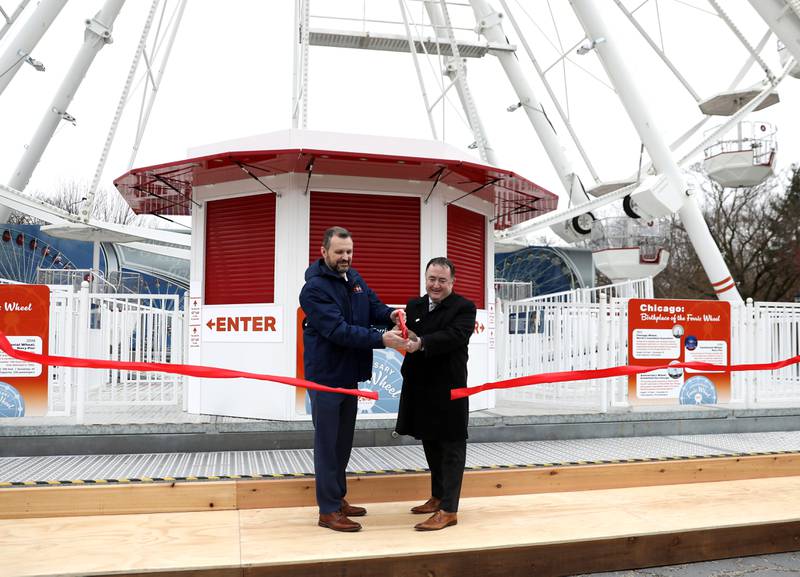 Brookfield Zoo President and CEO Dr. Mike Adkesson (left) and Brookfield Village President Michael Garvey (right) cut the ribbon for a 110-foot Ferris wheel in honor of the zoo’s 90th anniversary on Friday, March 15, 2024. The Ferris wheel offers guests unique bird’s-eye views of the park’s gardens, animal habitats and Chicago skyline.