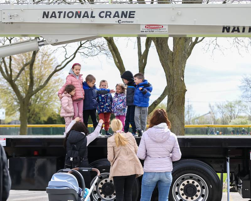 Children pose on the bed of a crane at the La Grange Touch a Truck event. April 22, 2023.