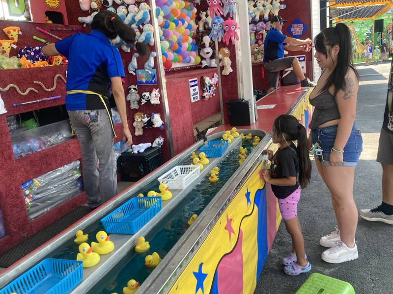 Players select prizes at the duck pond game at the carnival midway at the Shorewood Crossroads Festival on Saturday, August 2, 2025.