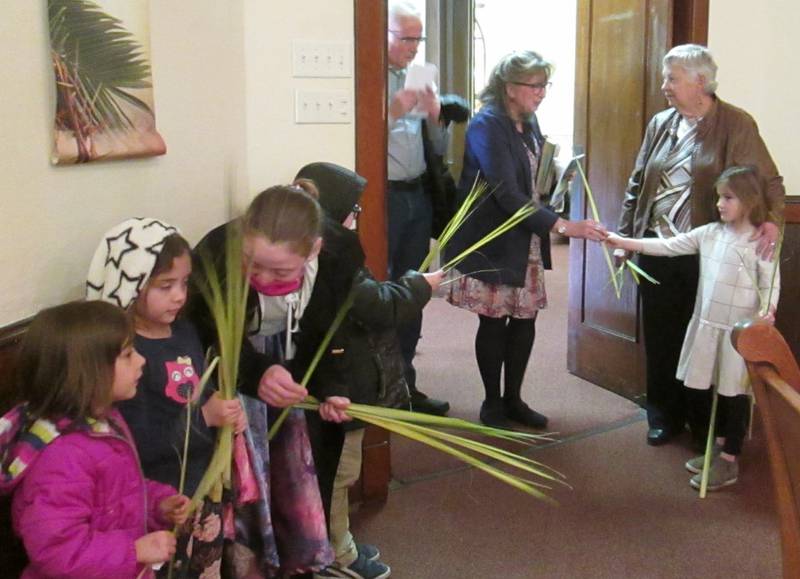 Children distribute palms to church family members on Palm Sunday at Plano's United Methodist Church.