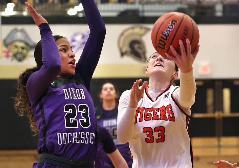 Crystal Lake Central's Katie Hamill goes to the basket against Dixon’s Ahmyrie McGowan during their Class 3A sectional semifinal Tuesday, Feb. 20, 2024, at Sycamore High School.