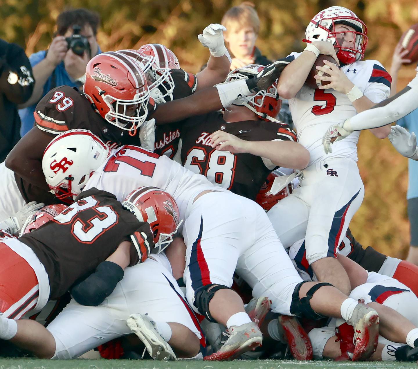 Hersey's Bernard Erhabor (99) gets a hand on St. Rita's Steven Armbruster (5) during the IHSA Class 6A Football Quarterfinal Saturday, Nov. 15, 2025 in Arlington Heights.