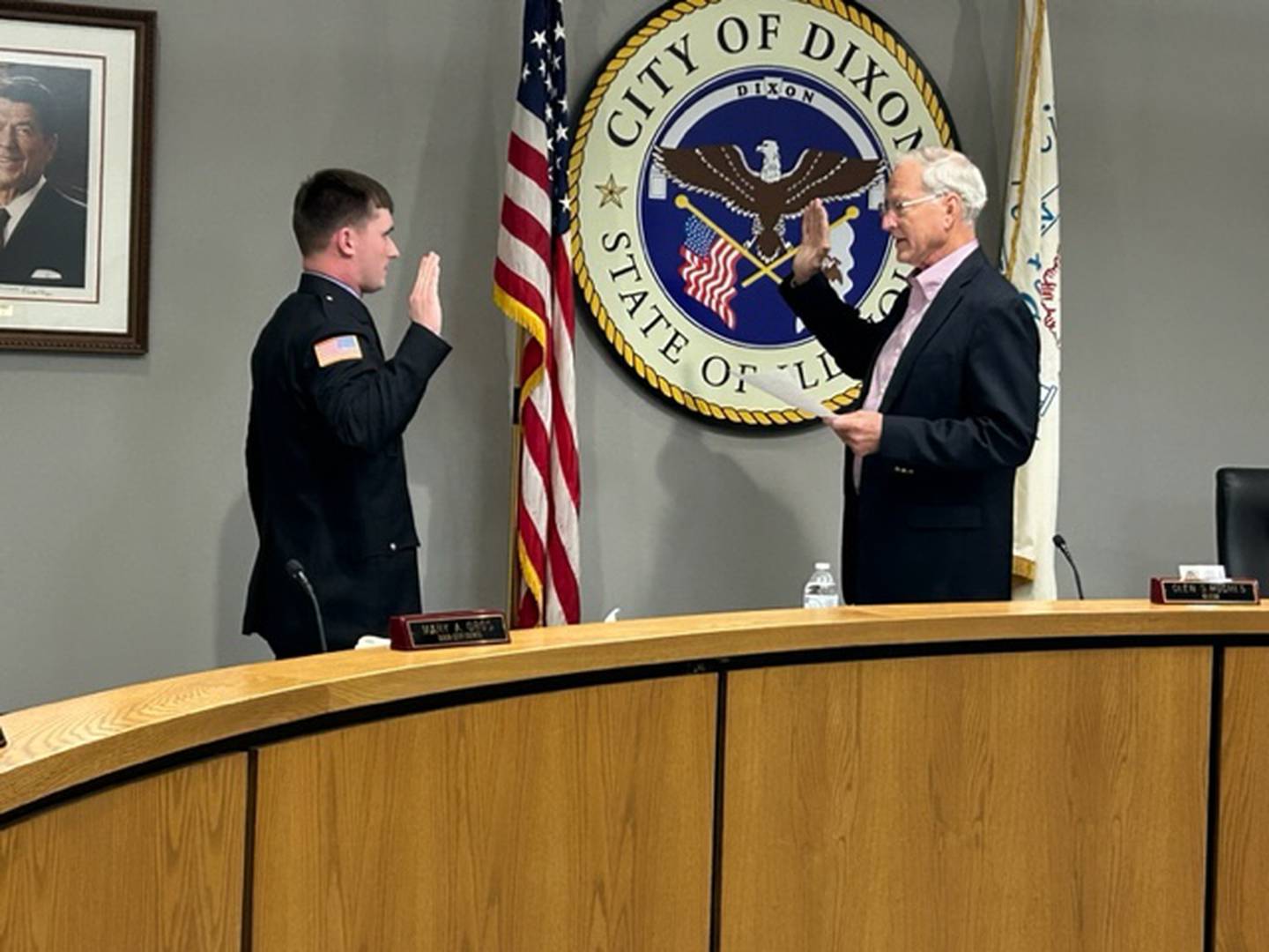Levy Johnson (left) takes the oath of office as read by Dixon Mayor Glen Hughes on Monday, Feb. 5, 2024, at Dixon City Hall.  Johnson was one of three firefighters sworn onto the department at Monday's city council meeting.