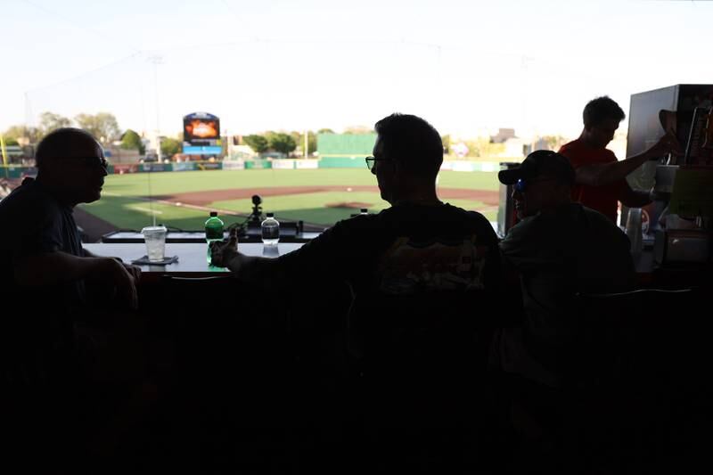 Fans sit at the bar overlooking DuPage Medical Group Field for the Joliet Slammers home opener against the Ottawa Titans. Friday, May 13, 2022, in Joliet.
