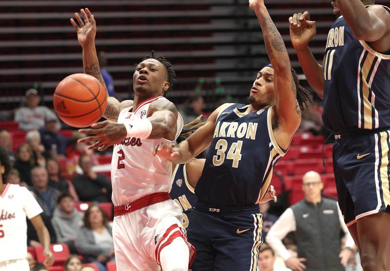Northern Illinois' Zarique Nutter and Akron’s Nate Johnson go after a loose ball during their game Tuesday, Jan. 2, 2024, in the Convocation Center at NIU in DeKalb.