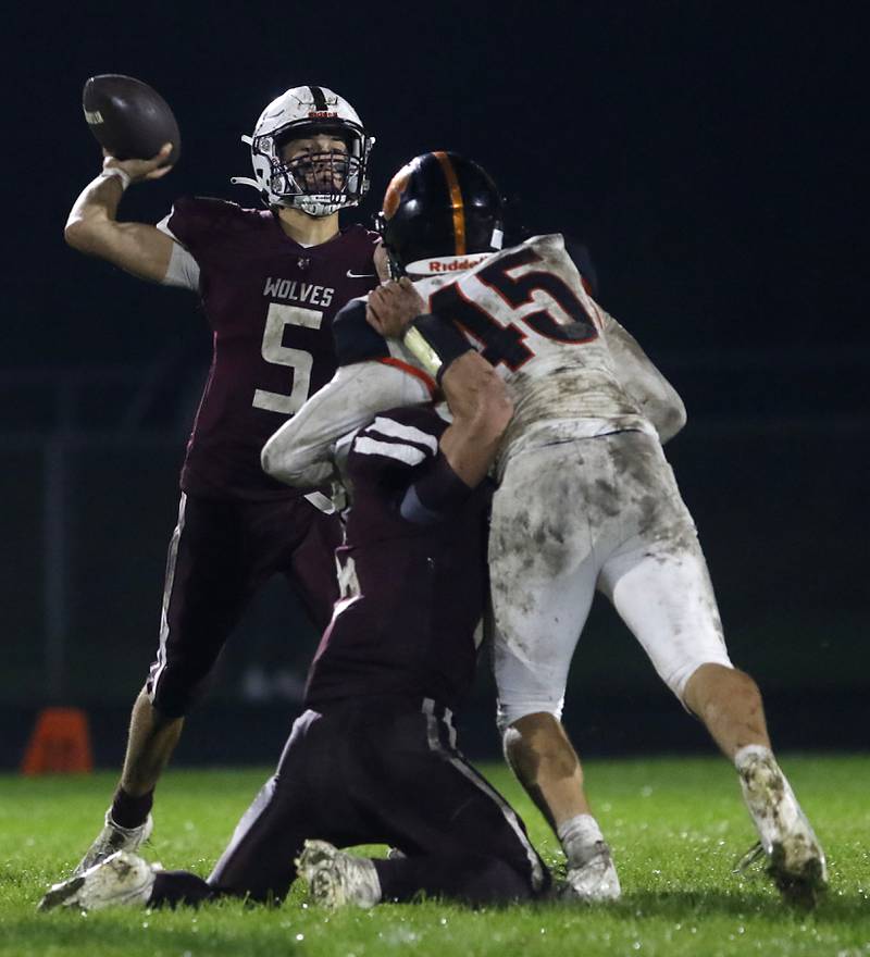 Prairie Ridge's Joseph Vanderwiel throws a pass as he is pressured by Crystal Lake Central's Ben Kolodziej during a Fox Valley Conference football game on Friday, Oct. 13, 2023, at Prairie Ridge High School in Crystal Lake.