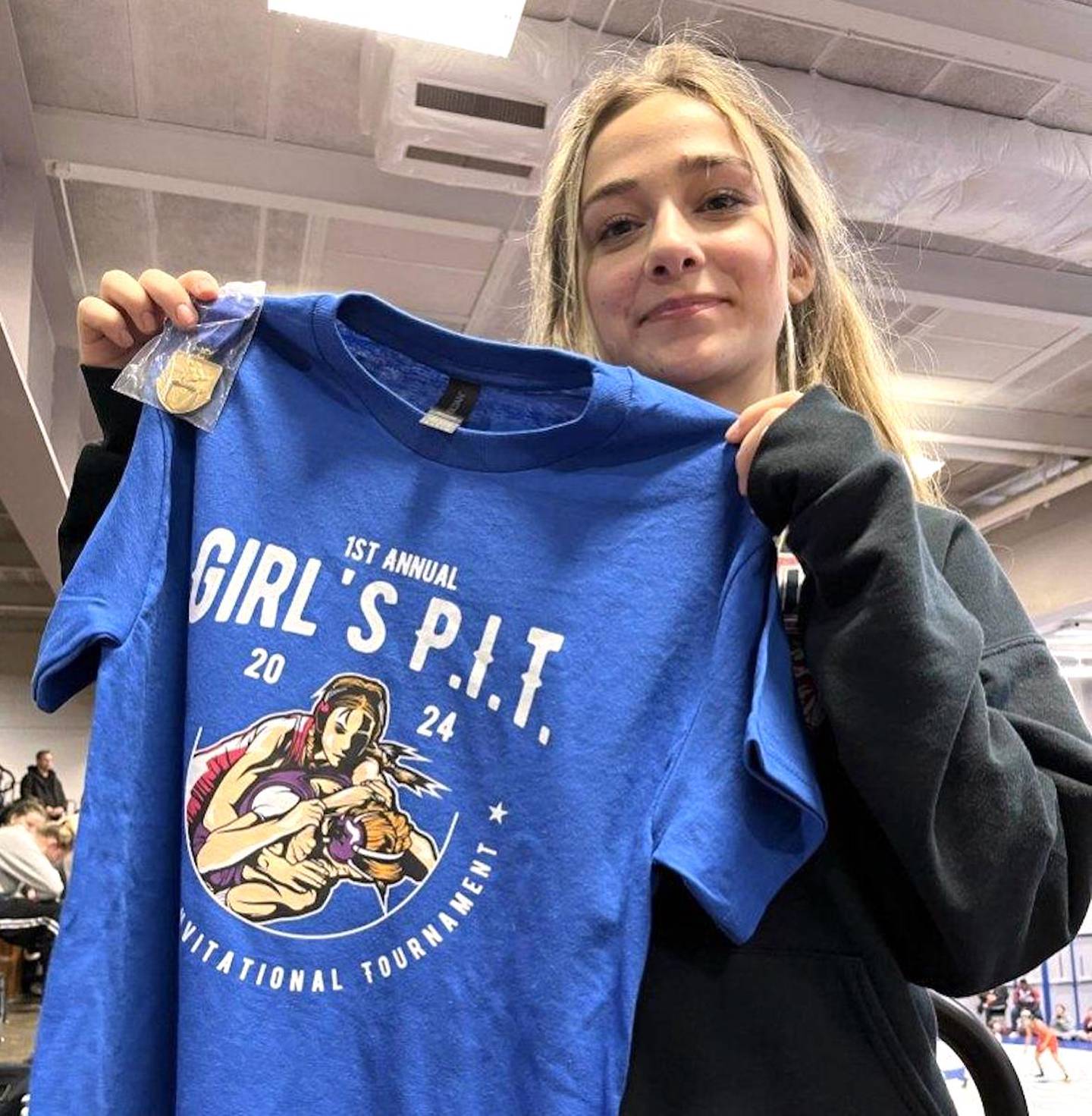 Addison Yacko holds a t-shirt from the inaugural Girls PIT.
