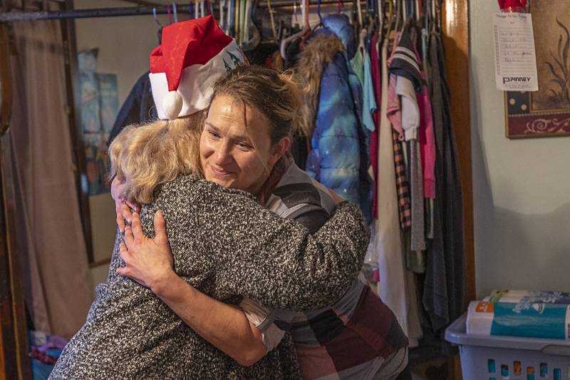A family member hugs Joy Colbert Monday, Dec. 22, 2025, after the gifts and food were delivered in Rock Falls.