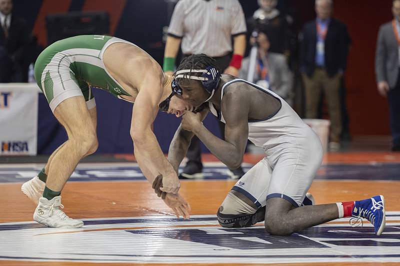 Coal City’s Brock Finch (left) faces off against Arkail Griffin in the 1A 175 pound class Saturday, Feb. 21, 2026, at the IHSA wrestling finals in Champaign.