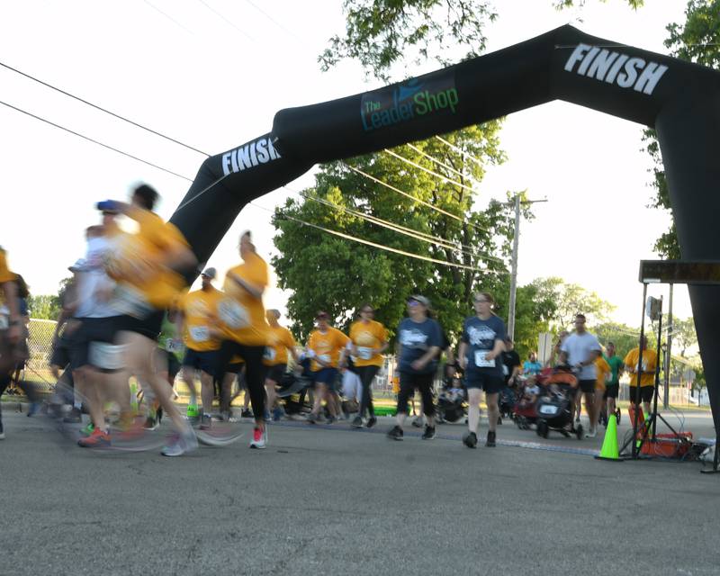 Runners and walkers take off from the start line of the Leadershop 5k event held on Friday June 9, 2023 in La Grange.