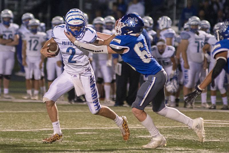 Princeton’s Teegan Davis stiff arms Newman's Caleb Donna Friday, Sept. 30, 2022.