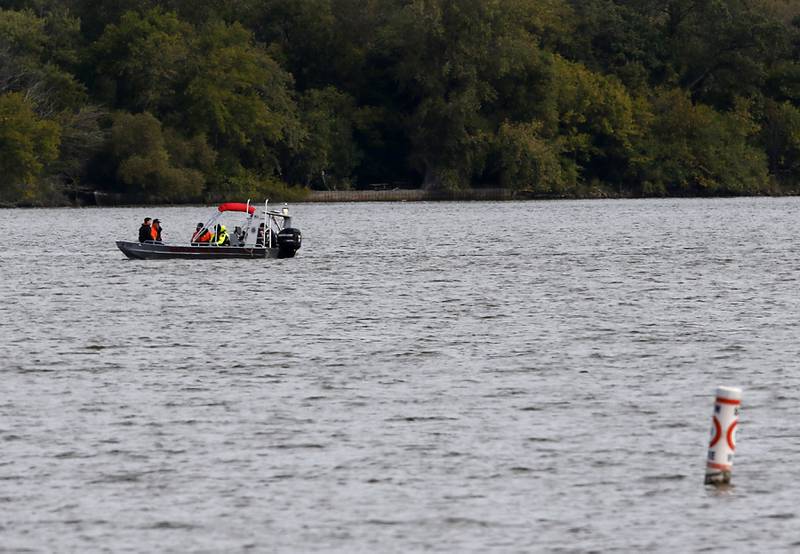 Divers from the Antioch Fire Protection District and a sonar team from the Illinois Department of Natural Resources continue searching Tuesday, Oct. 7, 2025, on Fox Lake near Antioch for a man thrown from a boat he was test driving Monday night.