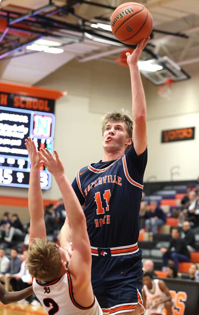 Naperville North's Jack Kallstrand shoots over DeKalb’s Sean Reynolds during their game Friday, Dec. 8, 2023, at DeKalb High School.