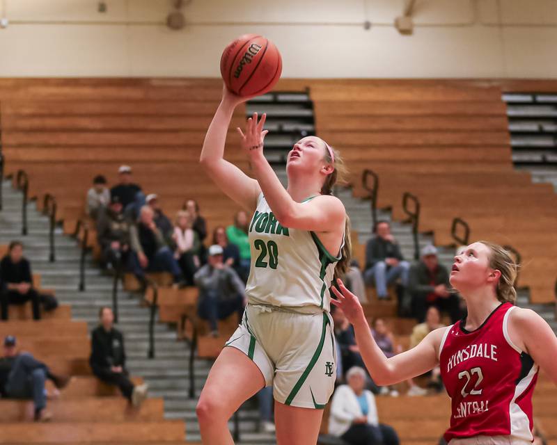 York's Hannah Meyers (20) goes up for a lay up during basketball game between Hinsdale Central at York. Dec 8, 2023.