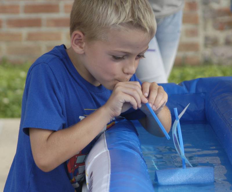 Bowen Boettcher  of Dixon gets his boat to move in the boat race at Venetian Night. Venetian Night in Dixon featured magicians, street performers, face painting, a spaghetti eating contest, mini boat races, a drone light show and more. The Discover Dixon event was held along the riverfront in Dixon on Aug. 9, 2025.