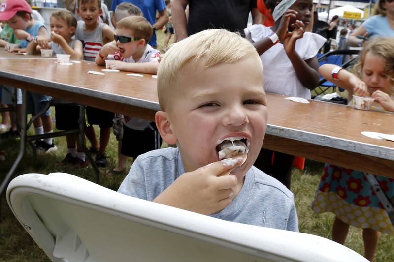 Vincent Bobula, 2, of Woodstock, eats ice cream as he competes in the ice cream eating contest during Lakeside Festival Friday, June 30, 2023, at the Dole and Lakeside Arts Park in Crystal Lake.