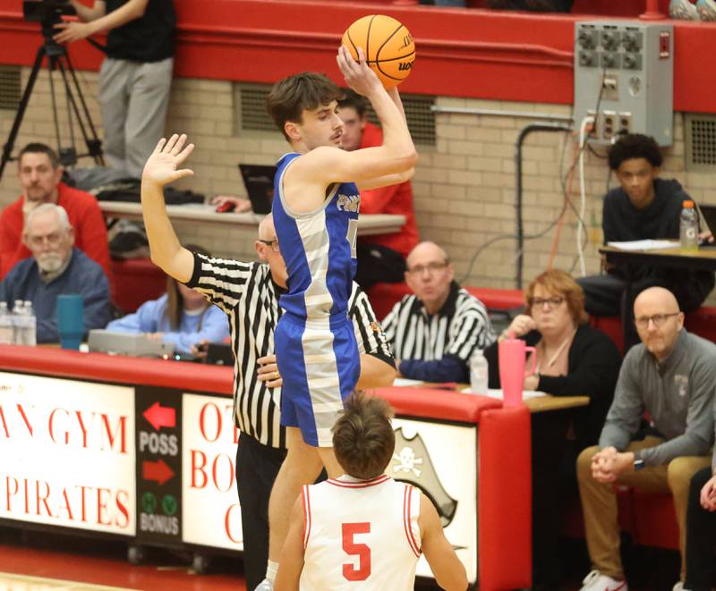Princeton's Gavin Lanham jumps in the air to catch a pass over Ottawa's Rory Moore during the Dean Riley Shootin' The Rock Thanksgiving Tournament on Monday Nov. 24, 2025 in Kingman Gymnasium at Ottawa High School.