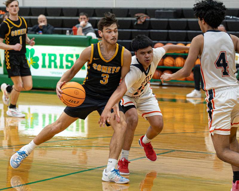 Jesse Tresouthick (3) of Reed-Custer dribbles ball as Enrique 'Kike' Lopez (13) of DePue reaches across body to steal ball during game in the Shipyard Showdown on Tuesday, December 23, 2025 at Seneca High School in Seneca.