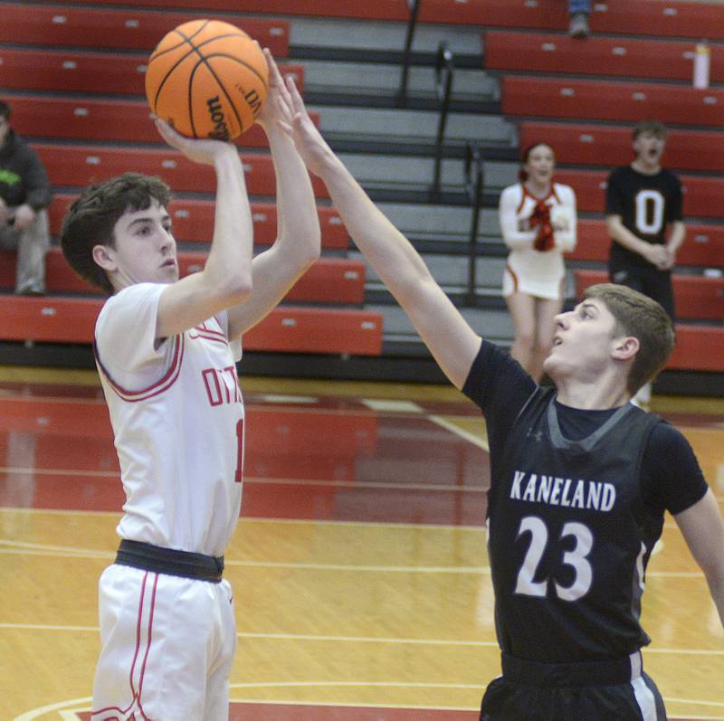 Kaneland’s Connor Kimme tries to block a 3 point shot from Ottawa’s Colt Bryson in the 1st quarter Tuesday at Ottawa.