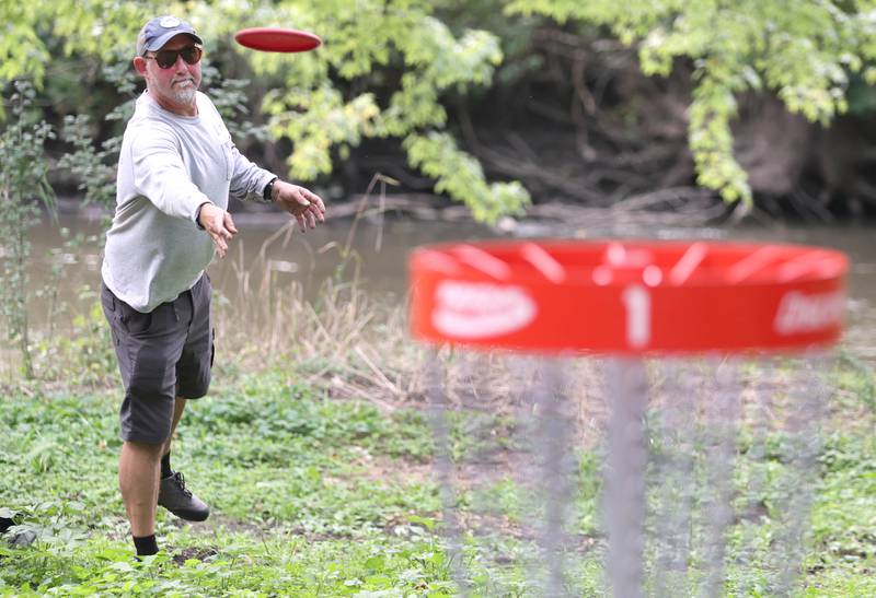 Kevin Schweitzer looks to finish out a hole Thursday, Sept. 2, 2022, at the new River Run Disc Golf Course in David Carroll Memorial Park in Genoa.