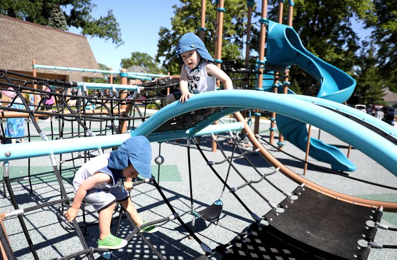 Declan, 2, and Nolan Fieldhouse explore the new equipment at the Elmhurst Park District’s new Centennial Park on Friday, June 17, 2022.