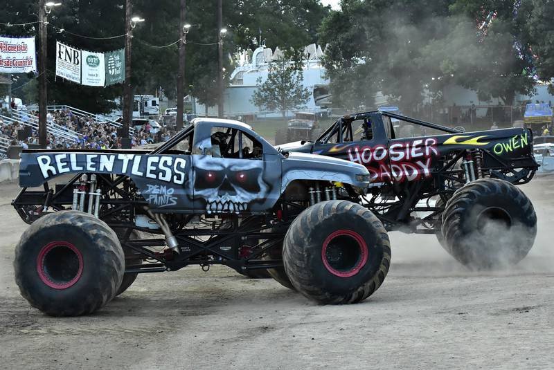 Hoosier Daddy, driven by Chris Rogers, went up against Relentless, driven by younger brother Bryant Rogers in a race around the track Thursday, Aug. 14, 2025, at the Whiteside County Fair in Morrison. The brothers were part of the Full Throttle Monster Truck team that brought five trucks to entertain the crowds.