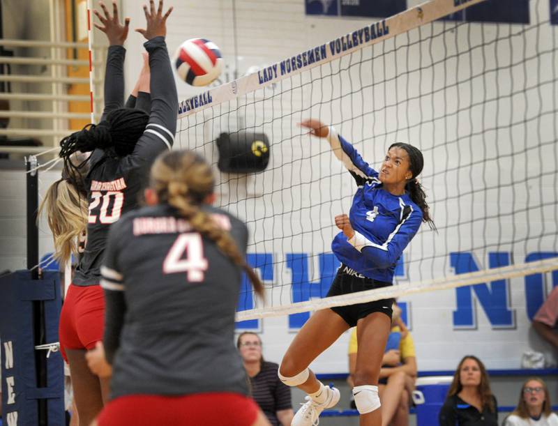 Newark's Kiara Wesseh (4) slams the ball into the Aurora Christian defense during a girls' volleyball match at Newark High School on Tuesday, Sep. 5, 2023.