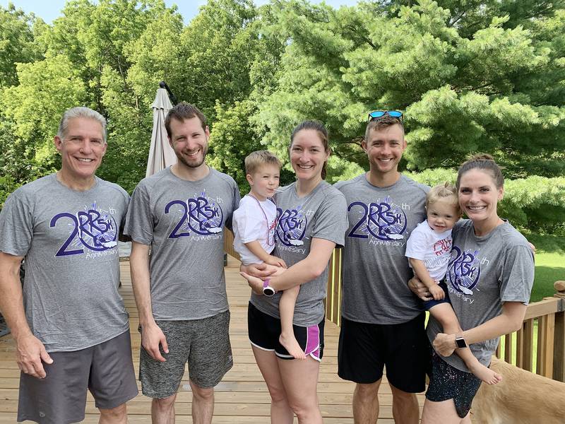 Stephanie Schmalzer (middle) has run in every Reagan Run except the first one, and through the years has convinced other family members to join her. In 2019, she ran with her father, Steve Bailey (left); her husband, Brian Schmalzer; her brother-in-law, Tyler Klotz; and her sister, Allison Klotz (right). Stephanie is holding her son, Finn Schmalzer, and Allison is holding her son, Kasen Klotz.