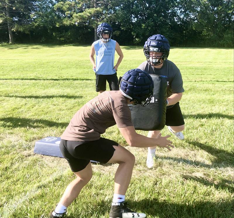 Cameron Lemons (left) and Connor Scott run drills during Tuesday's football practice at Bourquin Field in Manlius.