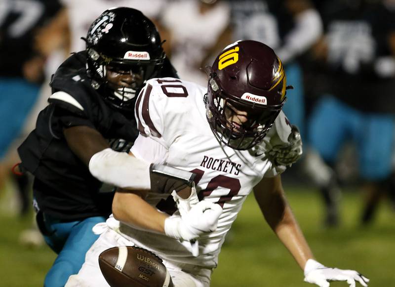 Woodstock North's Jr Fadahunsi knocks the ball away from Richmond-Burton's Luke Robinson during a Kishwaukee River Conference football game on Friday, Oct. 10, 2025, at Woodstock North High School.