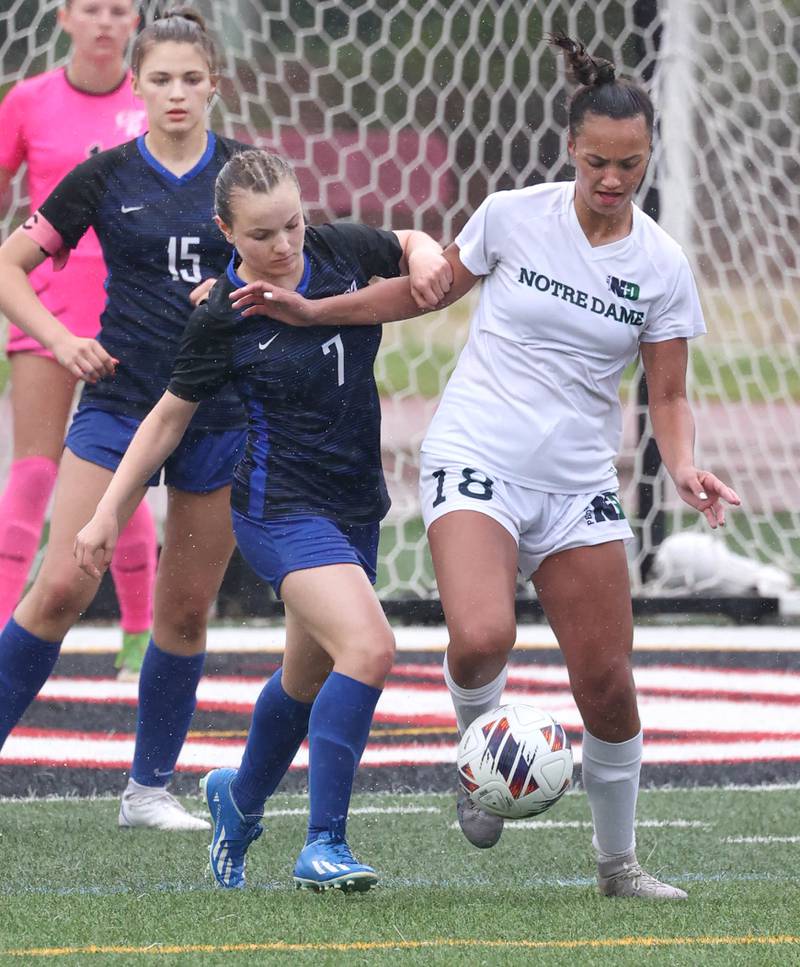 Burlington Central's Lily Batani (left) and Peoria Notre Dame's Ava LaFollette fight for a loose ball during their third place game Saturday, June 1, 2024, at the IHSA Class 2A state soccer finals at North Central College in Naperville.