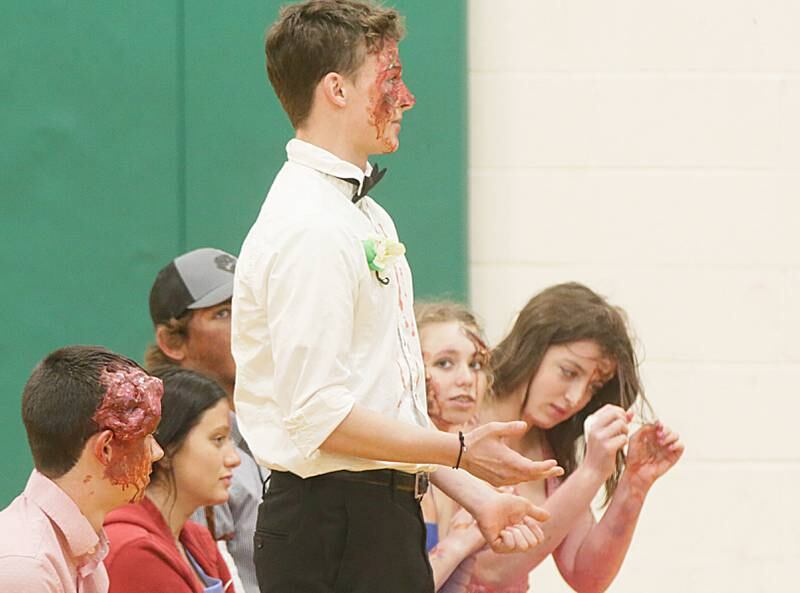 Tom Clifford, a student at Leland High School, speaks to classmates on his experience after participating in a Mock Prom drill at Leland High School on Friday, May 6, 2022 in Leland.
