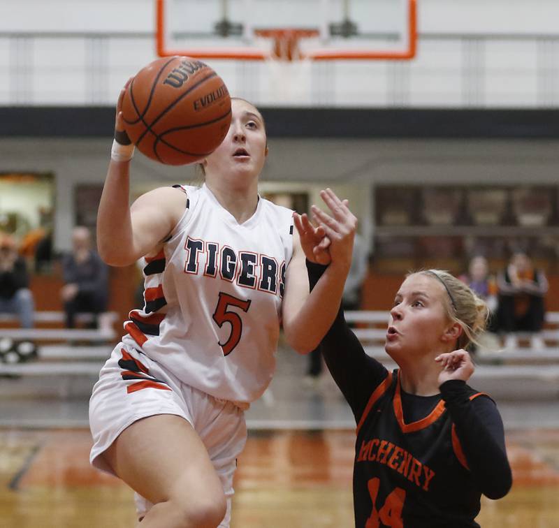 Crystal Lake Central's Addison Cleary drives to the basket against McHenry's Reese Kominoski during a Fox Valley Conference girls basketball game Tuesday, Nov.. 29, 2022, between Crystal Lake Central and McHenry at Crystal Lake Central High School.