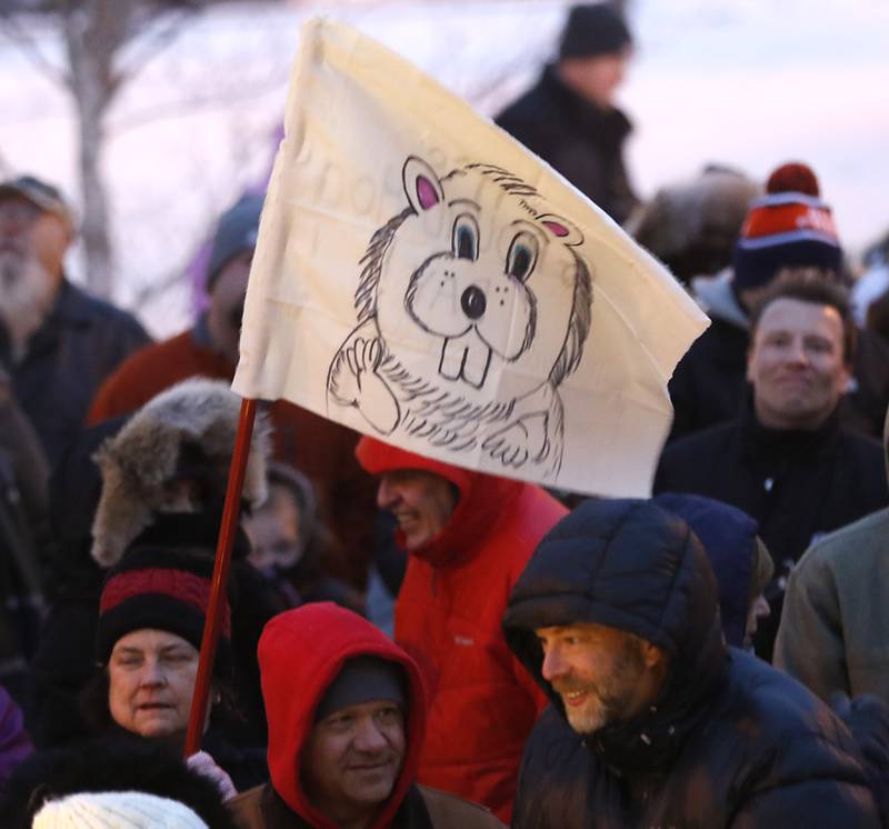 Sue Carolan holds her groundhog flag Wednesday, Feb, 2, 2022, during the annual Groundhog Day Prognostication on the Woodstock Square.