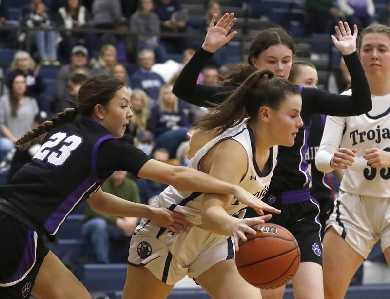 Hampshire's Lia Saunders tries to steal the ball from Cary-Grove's Emily Larry as Larry is guarded by Hampshire's Ashley Herzing during a Fox Valley Conference girls basketball game Friday, Dec.2, 2022, between Cary-Grove and Hampshire at Cary-Grove High School in Cary.