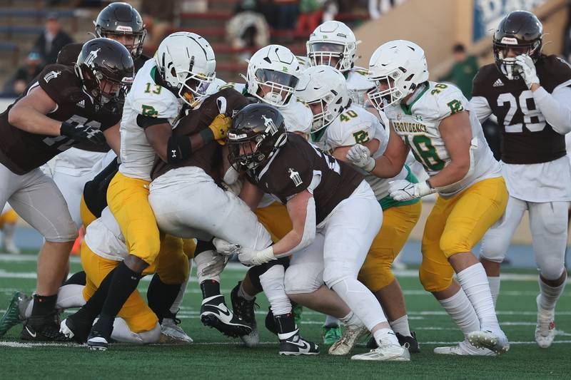 Joliet Catholic’s HJ Grigsby into a wall of Providence defenders in the Class 5A semifinal on Saturday, Nov. 18, 2023, in Joliet.
