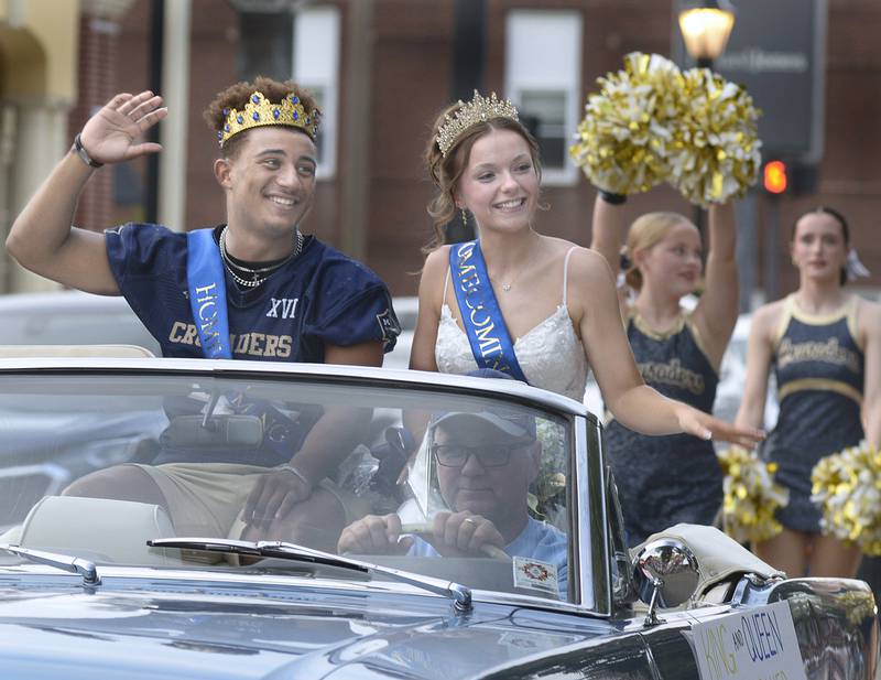 Marquette Academy High Homecoming King and Queen Marcus Baker and Ava Offermann wave to the crowd along LaSalle St in Ottawa Wednesday for the school’s Homecoming parade.