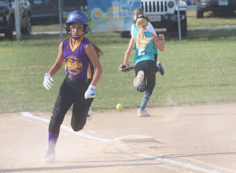 Warriors Alexis Samaniego rounds third base and eyes home as the ball gets by Edge's Kaylee Jered during the Ottawa Girls Fastpitch Association 11U City Championship on Wednesday July 2, 2025 at Peck Park in Ottawa.