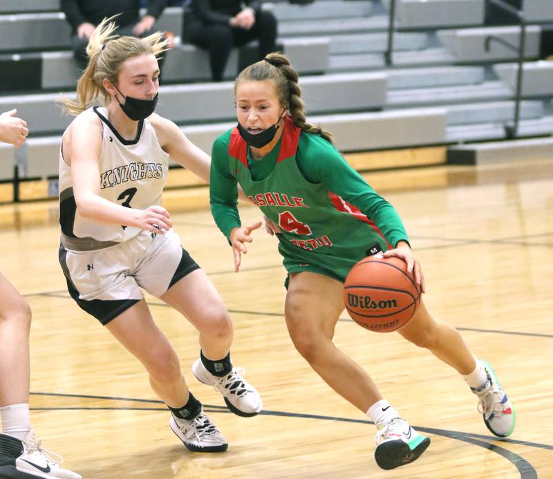 LaSalle-Peru's Brooklyn Ficek drives past Kaneland's Alexis Schueler during their game Wednesday, Feb. 9, 2022, at Kaneland High School in Maple Park.