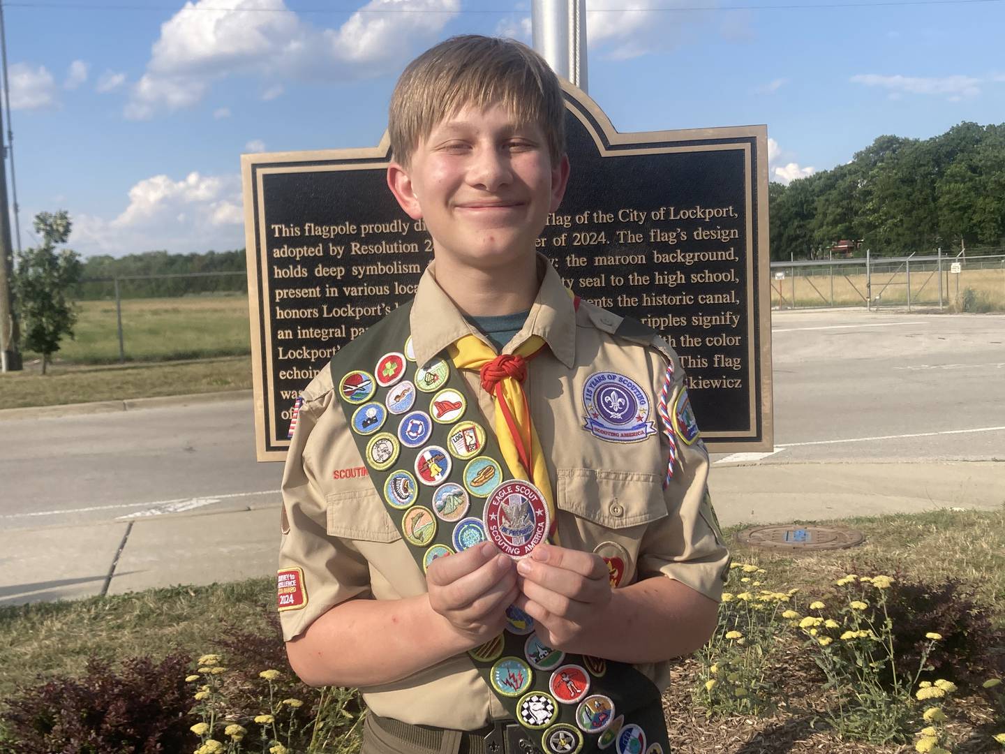 Zachary Dylkiewicz, 14, poses with his Eagle Scout patch, which he received in part for his efforts to create the new Lockport city flag. 
Wednesday, July 2, 2025.