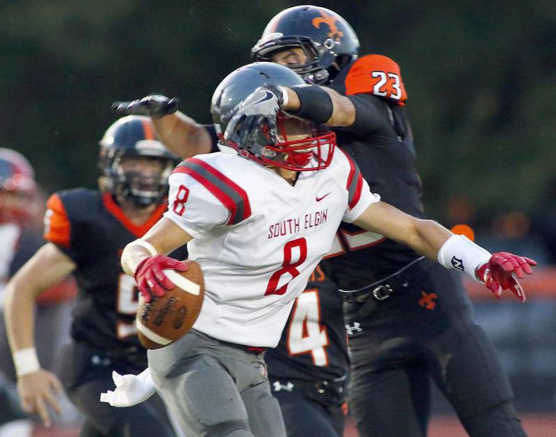 St. Charles East's Sebastian Grohe (right) wraps up South Elgin's Nate Gomez on Aug. 26. Grohe had one of the Saints' four interceptions in a 30-0 win against Geneva on Sept. 9.