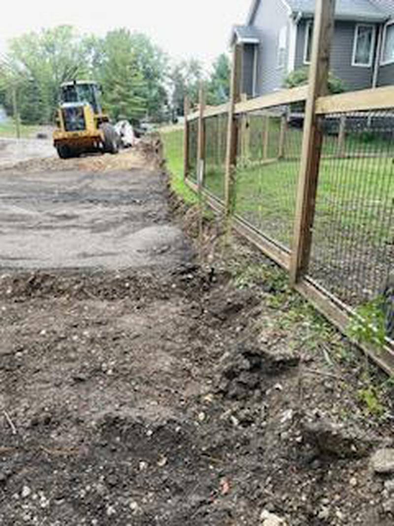 In photos taken Thursday, Sept. 14, 2023, resident Anthony Parker shows where his lot line meets a parking lot now being built  by the Nunda Township Highway District. Neighbors say they did not know a parking lot, set to access Moraine Hills State Park, was planned.