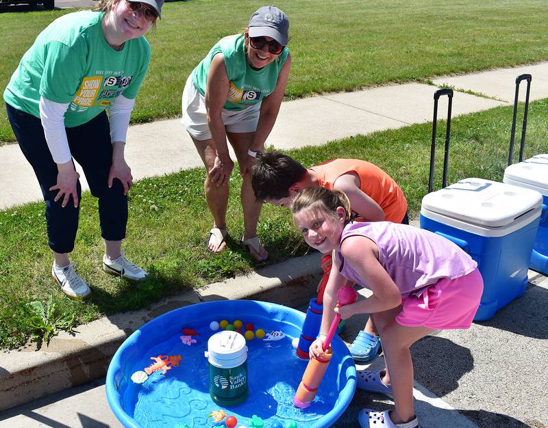 Christina Wolfe (left), Suzy Perino, Reid Smith, 5, and Kinzley Smith, 6, prepare for a water battle amid sweltering conditions Saturday, June 21, 2025, during Rock Falls’ Summer Splash.